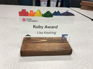 An award for the Tacoma Pride Festival. The award is made of wood and acrylic and depicts the Tacoma skyline